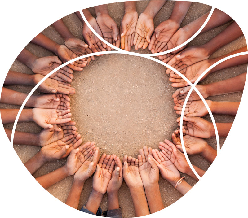 overhead shot of a number of people making a circle with their palms upturned